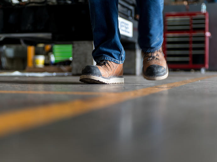 Man in safety boots walking a line